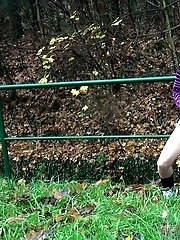 15 pictures - Brunette pisses while standing up next to a road