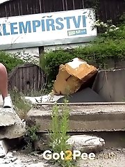 15 pictures - Hot blonde pisses onto a concrete slab